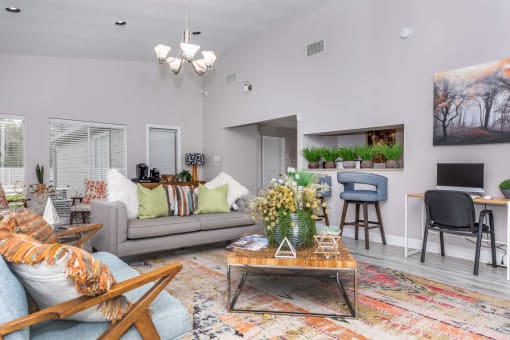 Living room with couch and tv and open kitchenat Royal Wildewood Manor Apartments, Clute, Texas