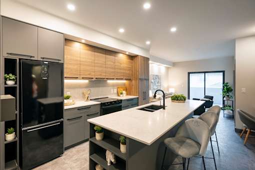 A modern kitchen with a large island and stainless steel appliances.