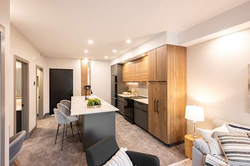 A modern kitchen with a dining table and chairs.