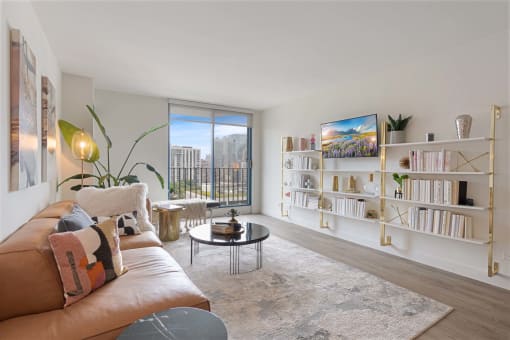 a living room with a leather couch and a large window