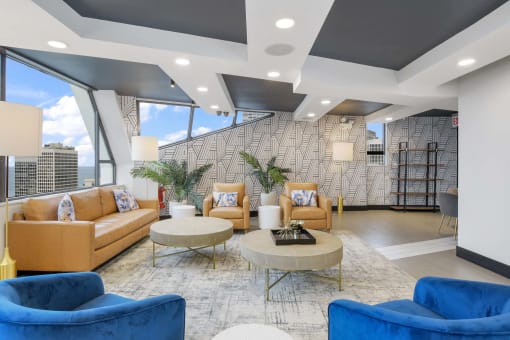 a lobby with couches and chairs and a table