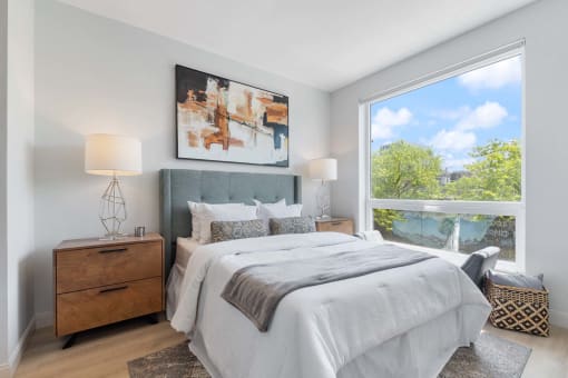 a bedroom with a bed and a large window