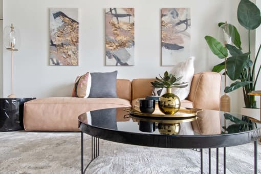 a living room with a brown couch and a black coffee table