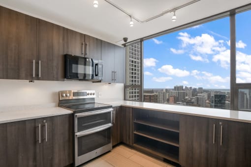 a kitchen with a large window and a city view