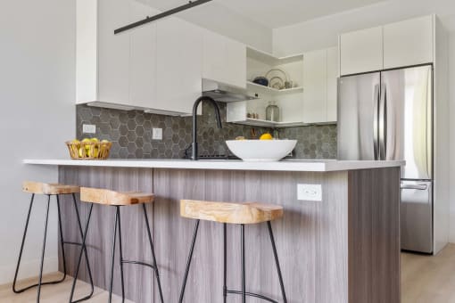 a kitchen with a counter top and three stools