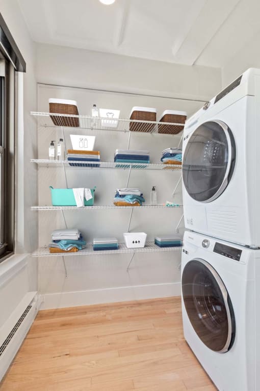 a laundry room with a washing machine and shelves