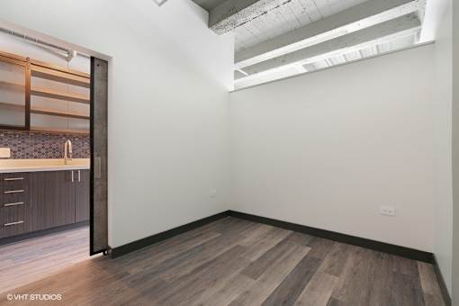 an empty room with a sink and a mirror