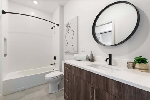 a bathroom with a sink and a toilet and a shower