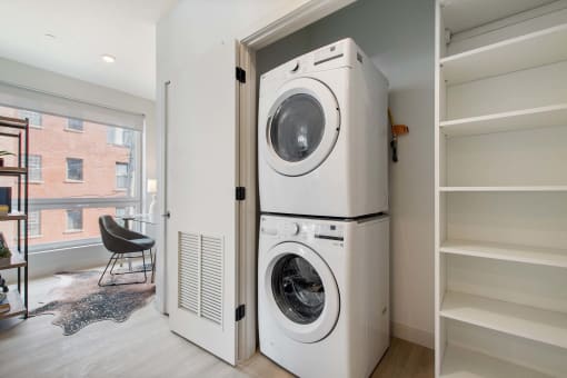 a washer and dryer in a closet in a living room