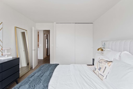 a bedroom with a large bed and a closet