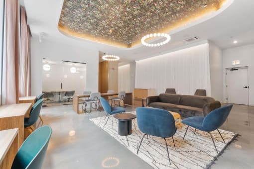 a living room with a couch and tables and chairs