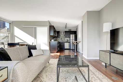 a living room with a couch and a glass table