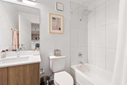 a white bathroom with a toilet sink and shower