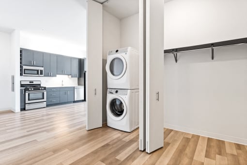 a washer and dryer in a living room with a kitchen