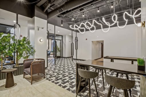 a lobby with a bar and chairs and a table