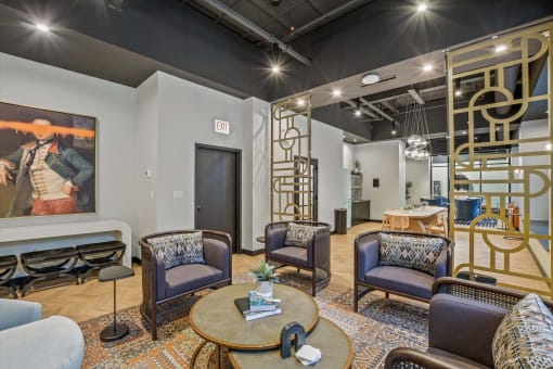 a living room with chairs and a table and a spiral staircase