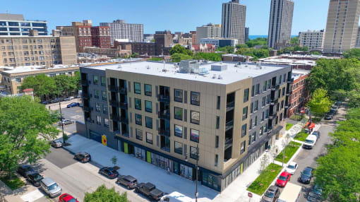 an aerial view of a building with a city in the background