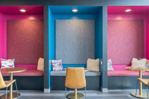 a room with two booths with chairs and a table