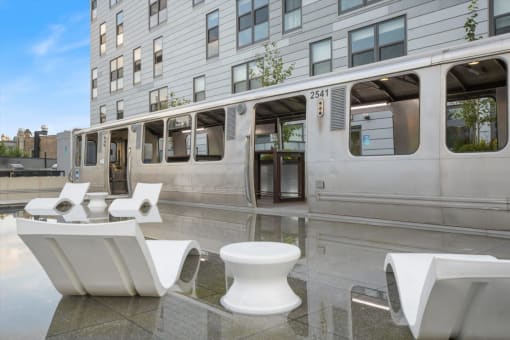 a row of toilets and urinals in front of a train