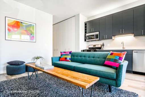 a living room with a green couch and a coffee table