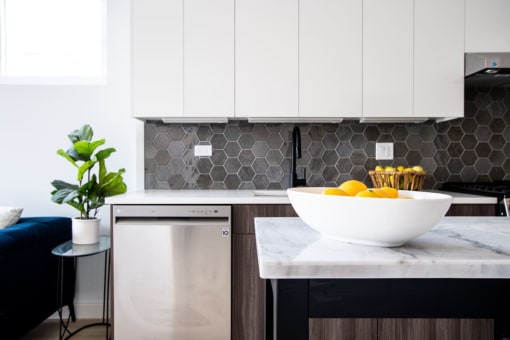 a kitchen with a bowl of fruit on the counter