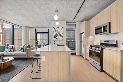 A modern kitchen with wooden cabinets and a large island.