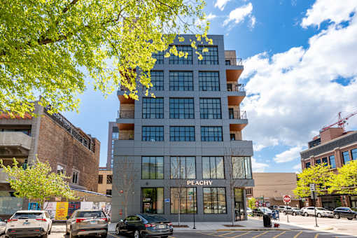 A modern building with the word "Peachy" on the front.