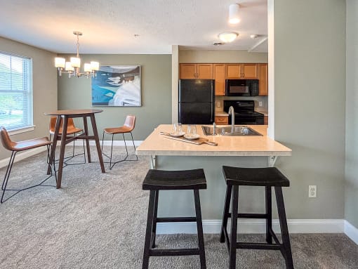 View of well equipped kitchen with breakfast bar and dining area