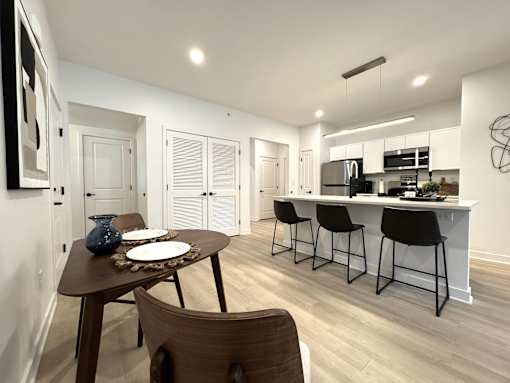 Typical great room dining & kitchen area with breakfast bar and stainless steel appliances