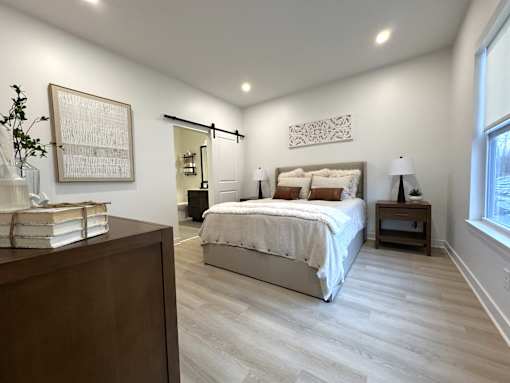 View of typical primary bedroom with en-suite bathroom & walk-in shower
