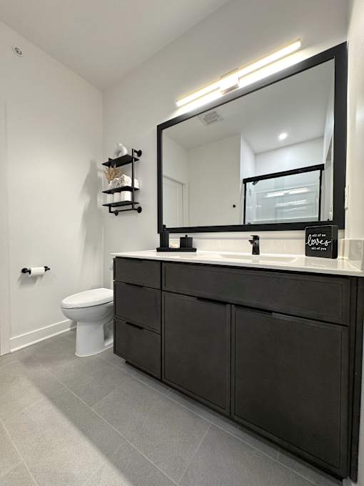 View of typical en-suite bathroom cabinetry & beautiful tile flooring
