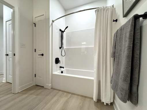 Typical second bathroom with tub/shower combo and linen closet