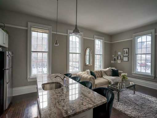 a living room with a kitchen counter and a couch