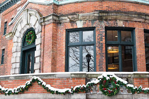 a brick building with christmas decorations on the windows