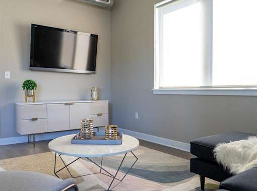 a living room with a television and a table
