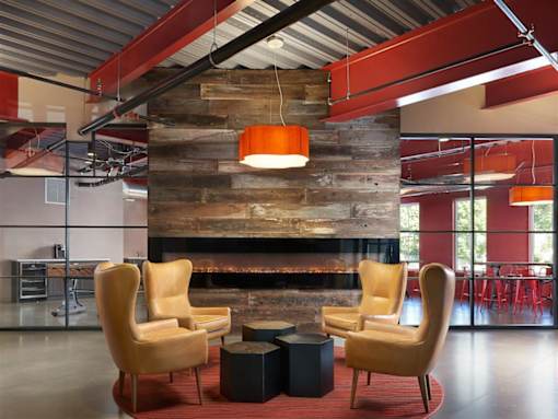 a living room with chairs and a fireplace