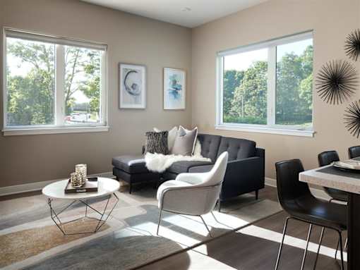 a living room with a couch and chairs and a table