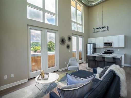 a living room with large windows and a couch
