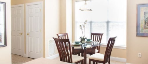 View from breakfast bar towards dining area of great room also showing storage and utility closet doors in hallway to bedroom View from breakfast bar towards dining area of great room also showing storage and utility closet doors in hallway to bedroom