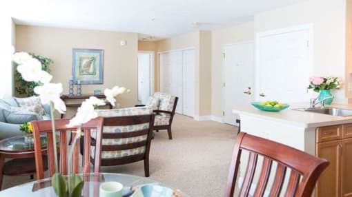 View from dining area of great room towards front entrance, living area, and kitchen area View from dining area of great room towards front entrance, living area, and kitchen area