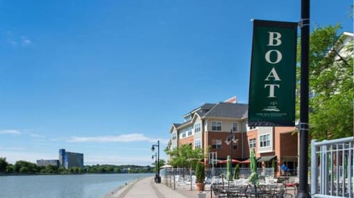 View of outdoor restaurant dining areas along the Genesee River at Corn Hill Landing and apartments above the shops and restaurants View of outdoor restaurant dining areas along the Genesee River at Corn Hill Landing and apartments above the shops and restaurants