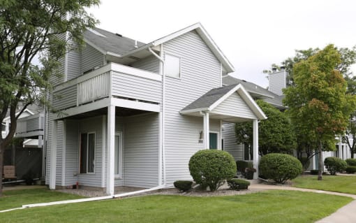 View of exterior showing wooden balcony and private, covered front entrance