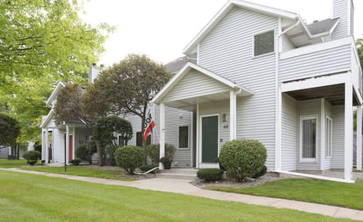View of typical private, covered front entrance and sidewalk