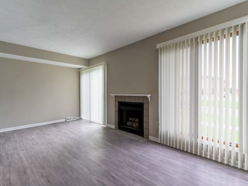 View of great room living area with fireplace and faux wood flooring