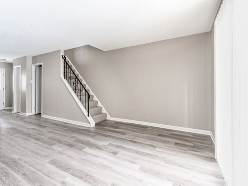 Interior of living/dining area in apartment home with faux wood flooring & without corner fireplace
