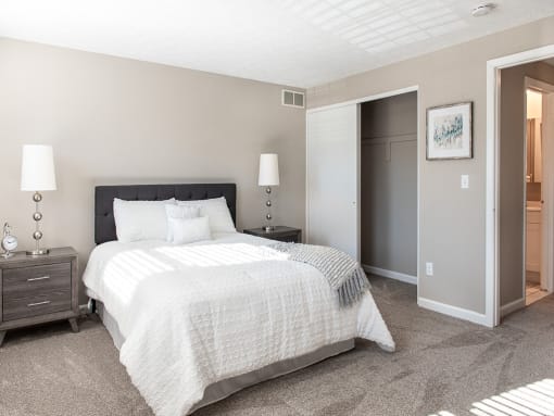 Another view of spacious primary bedroom with wall-to-wall carpeting & closet