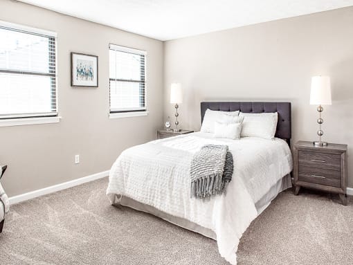 Spacious primary bedroom with wall-to-wall carpeting & closet