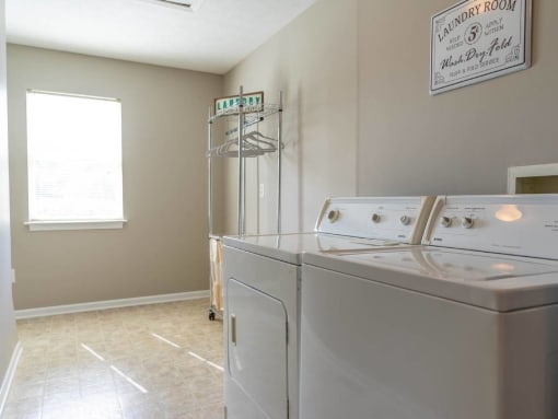 Interior view of large laundry room with full size washer & dryer