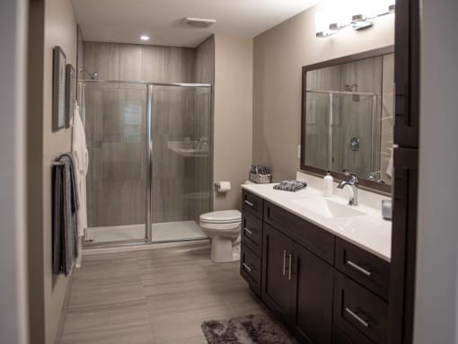 Interior view of Champion Reserve Townhomes primary bathroom with step-in shower.