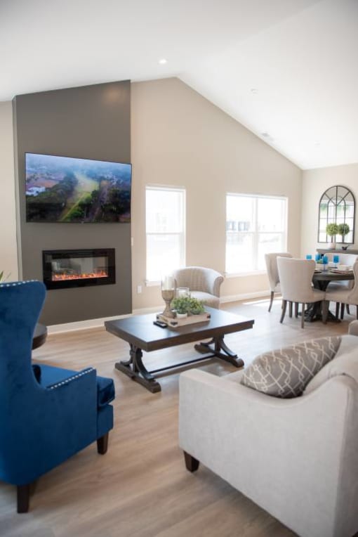 Interior of Champion Reserve Townhomes great room with cathedral ceiling, fireplace, and faux wood flooring.
